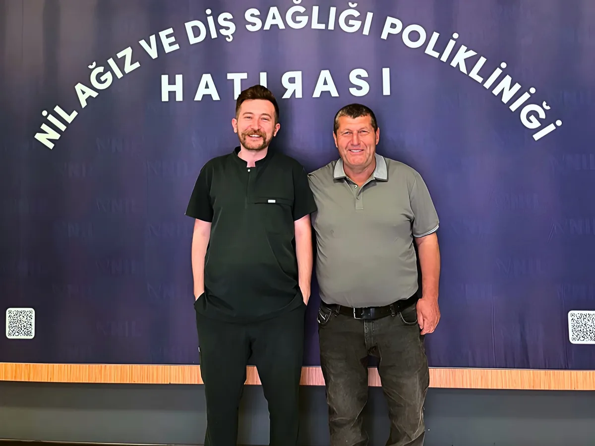 İmplant ve protez tedavisi tamamlanan hastamız, hekimiyle birlikte kliniğimizin hatıra panosu önünde